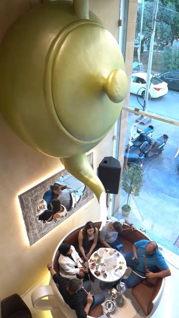 Guests beneath the giant teapot